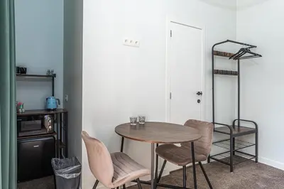 a dining room with a table and chairs at Room6 Van Lerius in Antwerp