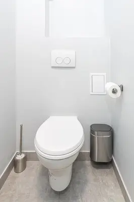 a bathroom with a white toilet and a trash can at Room6 Van Lerius in Antwerp