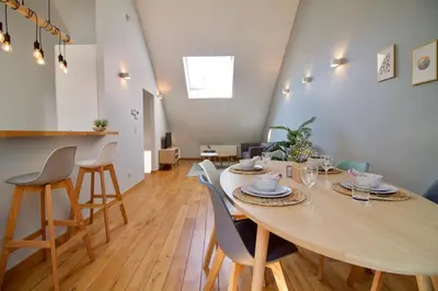 a dining room with a large wooden table and chairs at Heart of Grand Place - Stunning 2BR Duplex in Brussels
