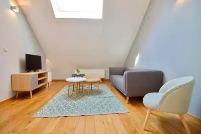 a living room with a couch and a table at Heart of Grand Place - Stunning 2BR Duplex in Brussels