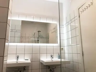 a bathroom with two sinks and a mirror at Heart of Grand Place - Stunning 2BR Duplex in Brussels