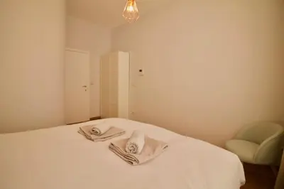 a bedroom with a bed with two towels on it at Heart of Grand Place - Stunning 3BR Triplex in Brussels