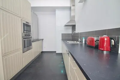 a kitchen with a red appliance on a counter at Heart of Grand Place - Stunning 3BR Triplex in Brussels