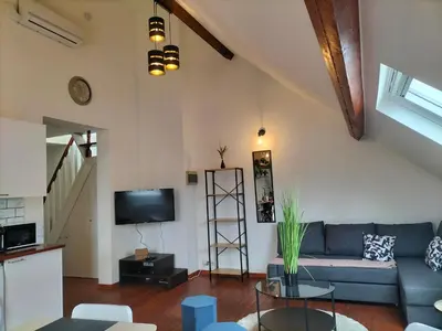 a living room with a blue couch and a tv at New Cozy Apartments In Porte de HAL in Brussels