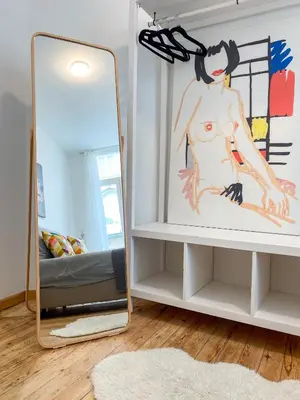 a mirror on a shelf next to a bed at New Cozy Apartments In Porte de HAL in Brussels