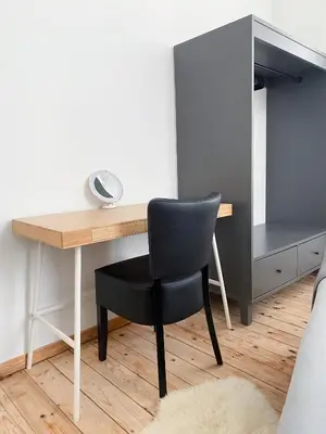 a black chair sitting at a desk in a room at New Cozy Apartments In Porte de HAL in Brussels