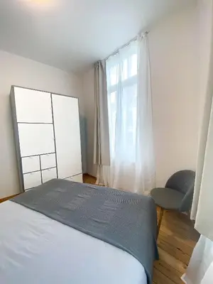 a bedroom with a bed and a window at New Cozy Apartments In Porte de HAL in Brussels