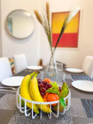 a bowl of fruit sitting on a table at New Cozy Apartments In Porte de HAL in Brussels