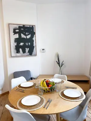 a dining room table with a bowl of fruit on it at New Cozy Apartments In Porte de HAL in Brussels