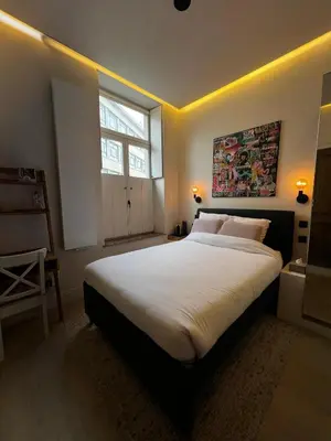 a bedroom with a large white bed with a window at Roxy's Fishmarket in Leuven
