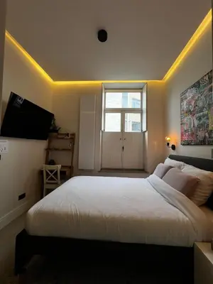 a bedroom with a large white bed and a window at Roxy's Fishmarket in Leuven