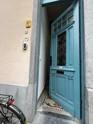 a blue door of a building with a bike in front at Roxy's Fishmarket in Leuven