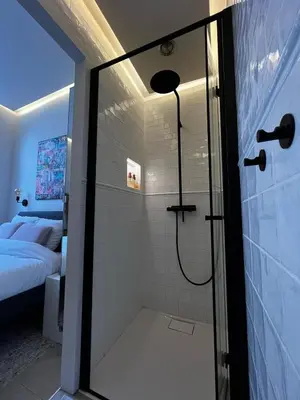 a bathroom with a shower with a glass door at Roxy's Fishmarket in Leuven