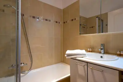 a bathroom with a tub and a sink and a shower at Jette Expo Duplex Residence in Brussels