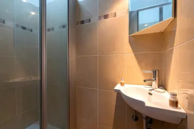 a bathroom with a sink and a shower at Jette Expo Duplex Residence in Brussels
