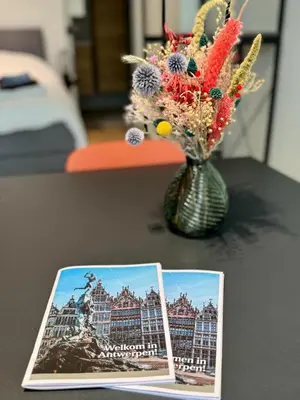 a picture of a vase with flowers on a table at J1 - Urban studio in Antwerp in Antwerp