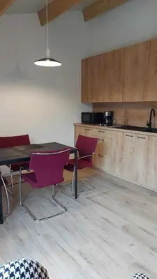 a kitchen with a table and chairs in a room at Juffertje in't groen in Tessenderlo