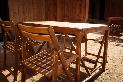 a wooden table with a wooden chair and a wooden table and a wooden table at Juffertje in't groen in Tessenderlo