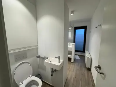 a bathroom with a toilet and a sink at Penthouse Apartment in Brussels with Stunning View in Brussels