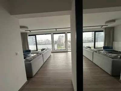 a waiting room with couches and windows in a building at Penthouse Apartment in Brussels with Stunning View in Brussels