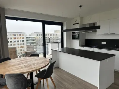 a kitchen with a table and a large window at Penthouse Apartment in Brussels with Stunning View in Brussels