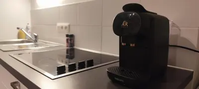 a black appliance sitting on a counter in a kitchen at Penthouse Apartment in Brussels with Stunning View in Brussels