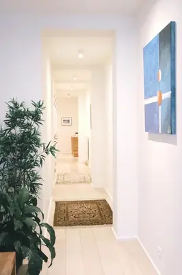 a hallway with white walls and a plant at Luxury 2 Bedroom - Antwerp City Centre in Antwerp