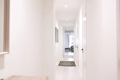 a hallway with white walls and a white door at Luxury 2 Bedroom - Antwerp City Centre in Antwerp