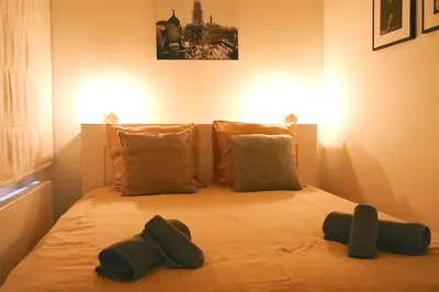 a bed with three pillows on it in a room at Luxury 2 Bedroom - Antwerp City Centre in Antwerp