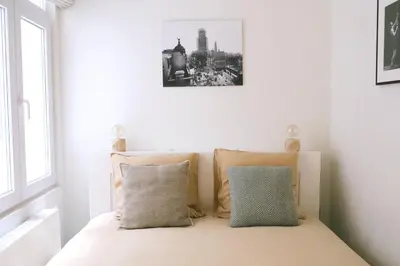 a bedroom with a bed with a black and white picture on the wall at Luxury 2 Bedroom - Antwerp City Centre in Antwerp