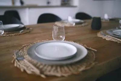a table with a plate and a wine glass on it at Luxury 2 Bedroom - Antwerp City Centre in Antwerp