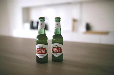 two bottles of beer sitting on a table at Luxury 2 Bedroom - Antwerp City Centre in Antwerp