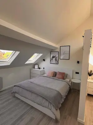 a bedroom with a bed and two skylights at Skyroof à Ixelles - Viaduc in Brussels