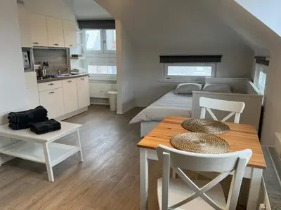 a room with a table and a bed and a kitchen at Sint-Amandstraat studio B4 in Ghent