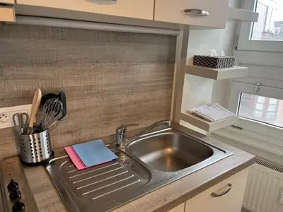a kitchen with a sink and a counter top at Sint-Amandstraat studio B4 in Ghent
