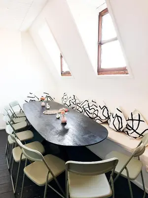 a dining room with a table and chairs at Le FauBourg Suites in Antwerp