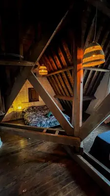 a attic room with a bed in the attic at Le FauBourg Suites in Antwerp