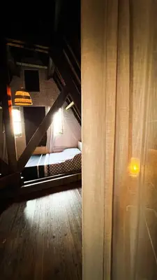 a room with a bed and a wooden floor at Le FauBourg Suites in Antwerp