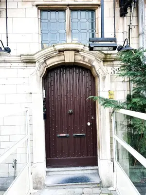 a brown door on the side of a building at Le FauBourg Suites in Antwerp