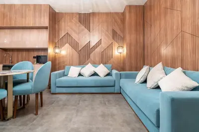a living room with blue couches and a table at luxueux appartement 5 chambre in Brussels