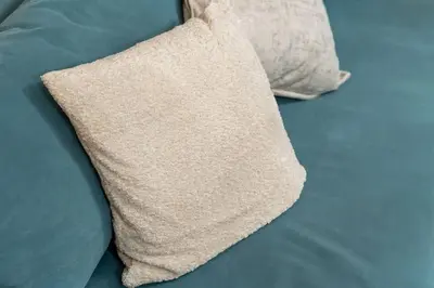 a pillow sitting on top of a bed at luxueux appartement 5 chambre in Brussels