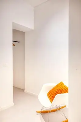 a white chair with a orange blanket on it at Wonderful 6P duplex in Antwerp in Antwerp