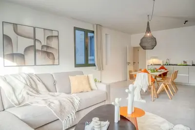 a living room with a couch and a table at Wonderful 6P duplex in Antwerp in Antwerp
