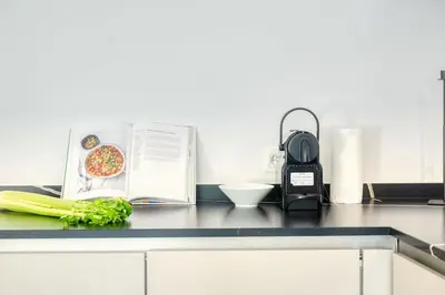 a kitchen counter with a book and vegetables on it at Wonderful 6P duplex in Antwerp in Antwerp