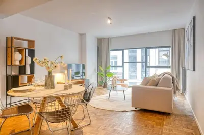a living room with a table and a couch at Smart and cosy 4P Apt in Antwerp with balcony in Antwerp