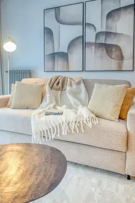 a living room with a couch and a table at Smart and cosy 4P Apt in Antwerp with balcony in Antwerp