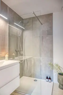a bathroom with a shower with a glass door at Smart and cosy 4P Apt in Antwerp with balcony in Antwerp