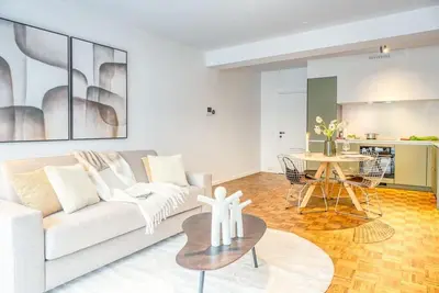 a living room with a white couch and a table at Smart and cosy 4P Apt in Antwerp with balcony in Antwerp