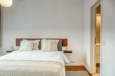 a bedroom with a large white bed with white pillows at Smart and cosy 4P Apt in Antwerp with balcony in Antwerp