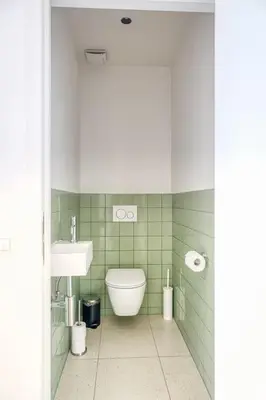 a bathroom with a toilet and a sink at Smart and cosy 4P Apt in Antwerp with balcony in Antwerp